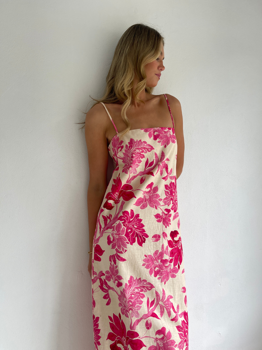 By Nicola Ivy maxi dress in pink floral print with column silhouette, straight neckline and side split, perfect for weddings and summer events.