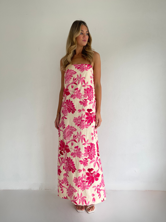 By Nicola Ivy maxi dress in pink floral print with column silhouette, straight neckline and side split, perfect for weddings and summer events.