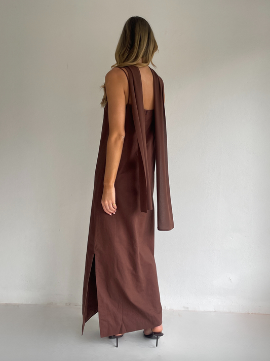 By Nicola Ivy maxi dress in chocolate brown cotton-linen with straight neckline, side slit, column style and chiffon neck tie, ideal for weddings and summer events.