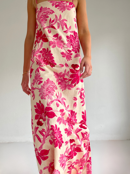 By Nicola Ivy maxi dress in pink floral print with column silhouette, straight neckline and side split, perfect for weddings and summer events.