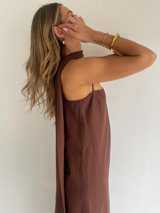 By Nicola Ivy maxi dress in chocolate brown cotton-linen with straight neckline, side slit, column style and chiffon neck tie, ideal for weddings and summer events.