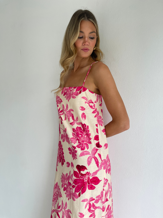 By Nicola Ivy maxi dress in pink floral print with column silhouette, straight neckline and side split, perfect for weddings and summer events.