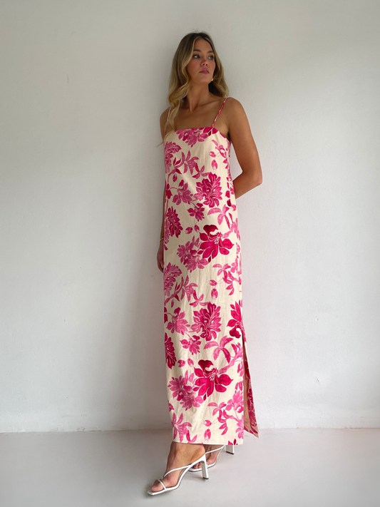 By Nicola Ivy maxi dress in pink floral print with column silhouette, straight neckline and side split, perfect for weddings and summer events.